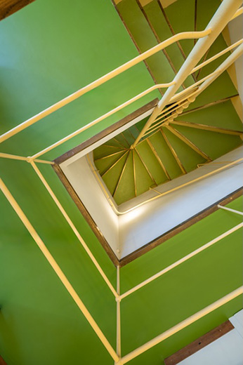 The service staircase connecting all floors stands out as an architectural feature.
